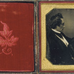 Gentleman looking at Daguerreotype Photo, ca. 1855