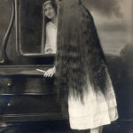 Mirror mirror on the wall, whose hair is the longest of them all?, ca. 1910s