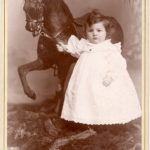 Boy with rocking horse, ca. 1890s