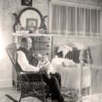 Man holding baby, ca. 1905-1910s