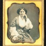 Smiling woman with sheer sleeves, ca. 1858
