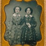 Two young woman in patterned dresses, 1850s