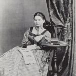 Lady with photo album, 1860s